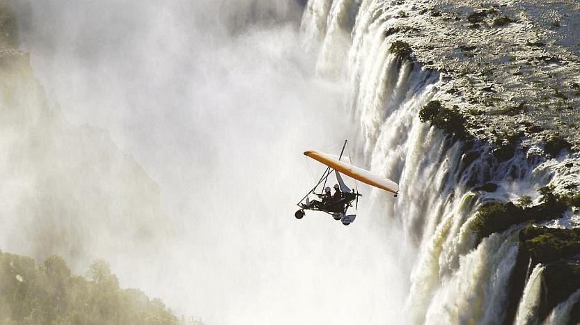 Reasons to enjoy a Zambia safari - micro-lighting over Victoria Falls