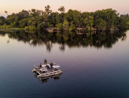 Permanent Water-based camps in Okavango delta, barge dinner in the river 