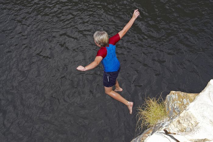 Mark jumping into a rock pool